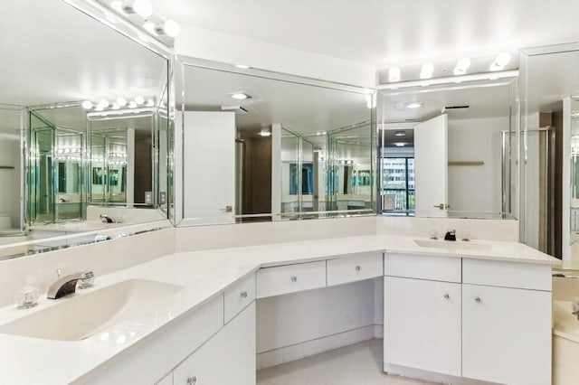 bathroom with tile patterned flooring, vanity, and a shower with door