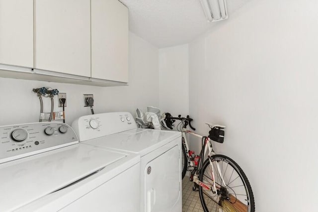 laundry area featuring cabinets and washing machine and clothes dryer