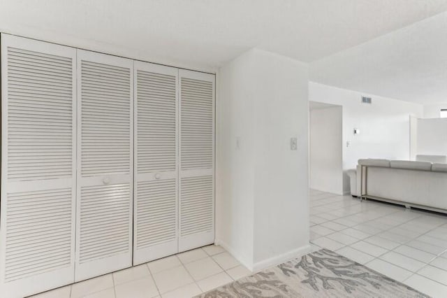 hallway featuring light tile patterned floors