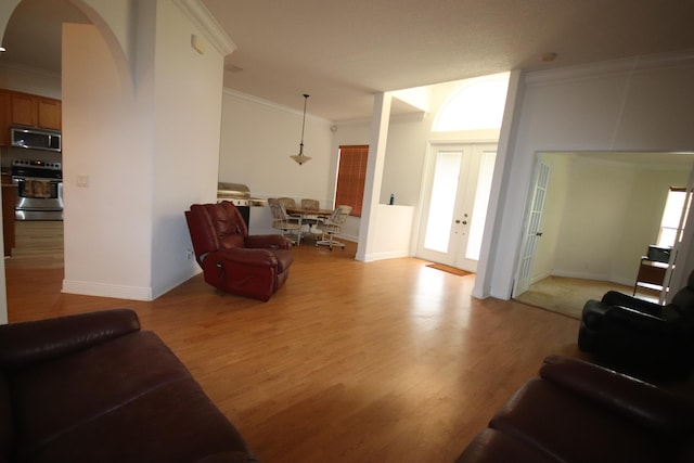 living room with light hardwood / wood-style floors and ornamental molding