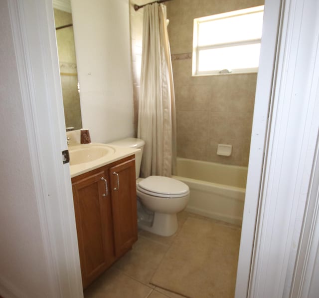 full bathroom featuring vanity, shower / bath combo with shower curtain, tile patterned flooring, and toilet