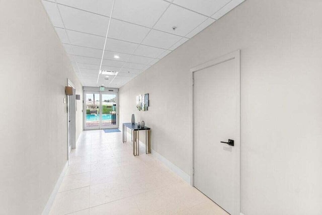 hallway featuring a drop ceiling