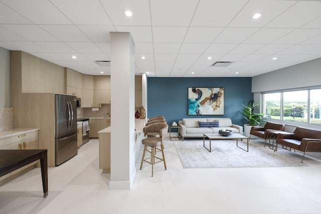 living room with a paneled ceiling