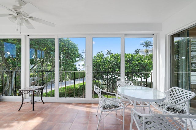 unfurnished sunroom with ceiling fan