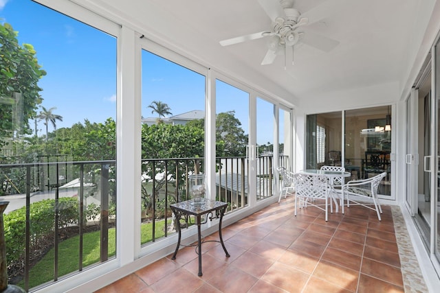 unfurnished sunroom featuring ceiling fan