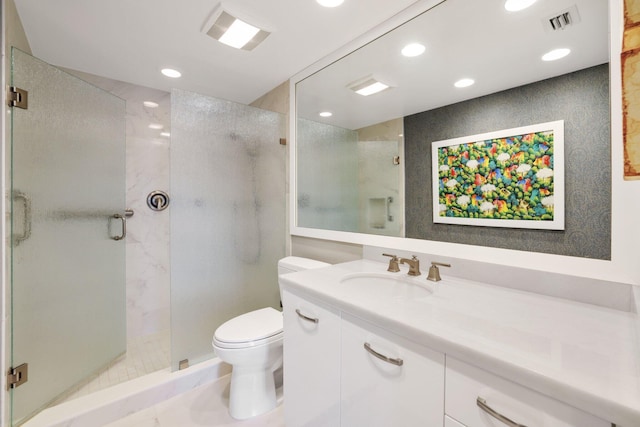 bathroom featuring vanity, toilet, and a shower with shower door