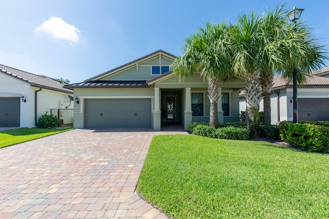 view of front facade with a garage and a front yard