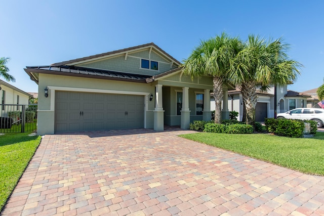 view of front of house featuring a garage and a front yard