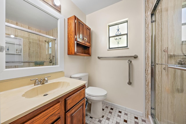 bathroom featuring toilet, an enclosed shower, and vanity