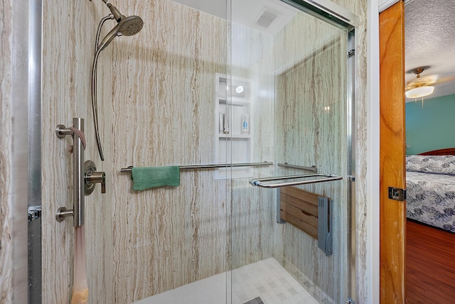 bathroom featuring a textured ceiling and an enclosed shower