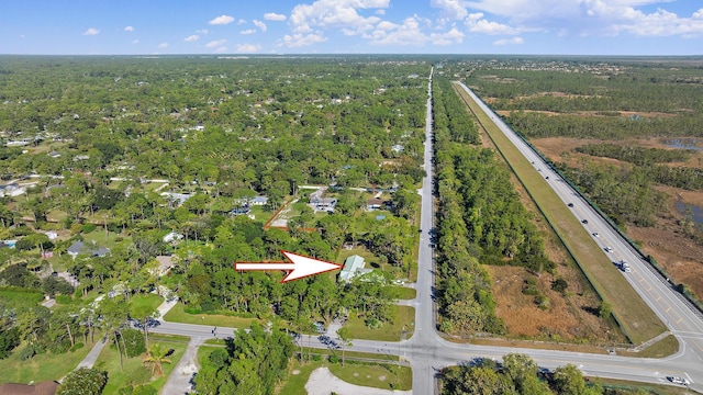 birds eye view of property with a forest view