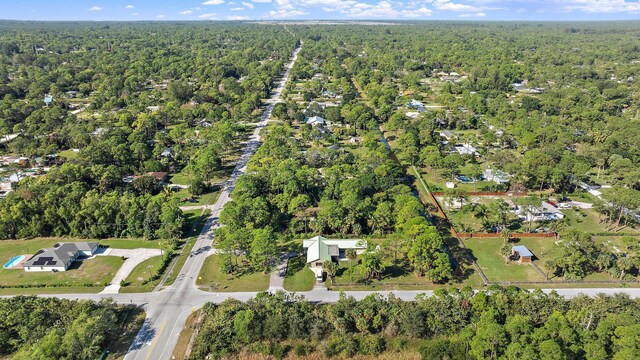 drone / aerial view with a water view and a wooded view