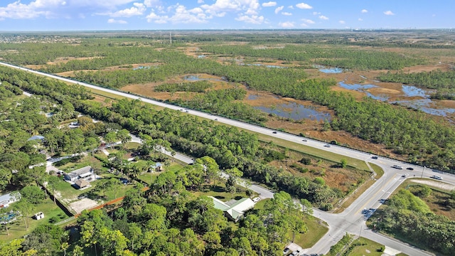 birds eye view of property with a water view and a view of trees