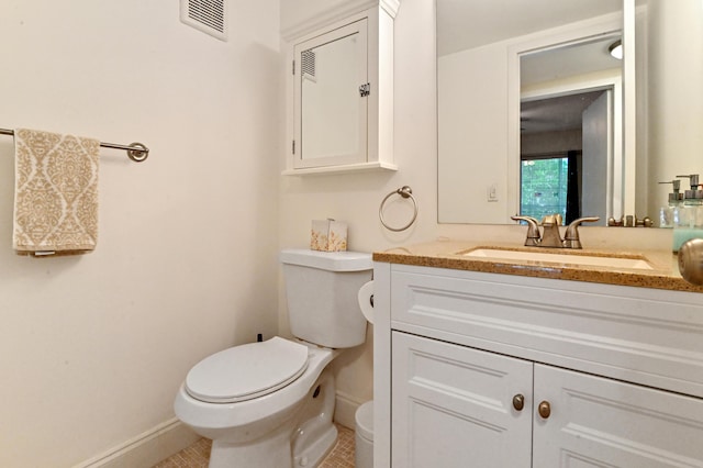 bathroom with tile patterned floors, vanity, and toilet