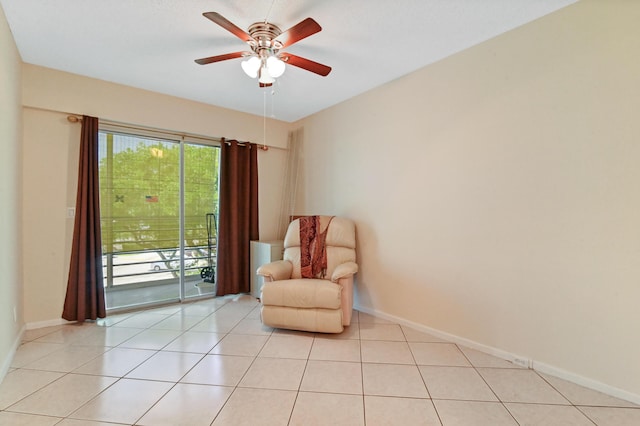 living area with light tile patterned floors and ceiling fan