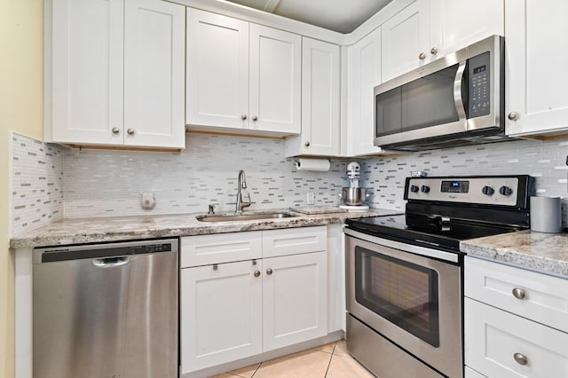 kitchen with sink, white cabinets, and appliances with stainless steel finishes