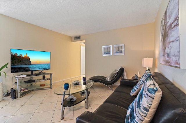 tiled living room featuring a textured ceiling