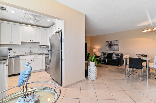 kitchen with white cabinetry, sink, and appliances with stainless steel finishes