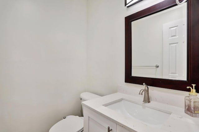 bathroom featuring vanity and toilet