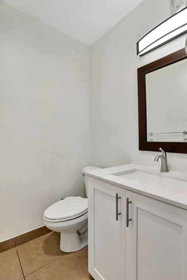 bathroom featuring tile patterned floors, toilet, and vanity