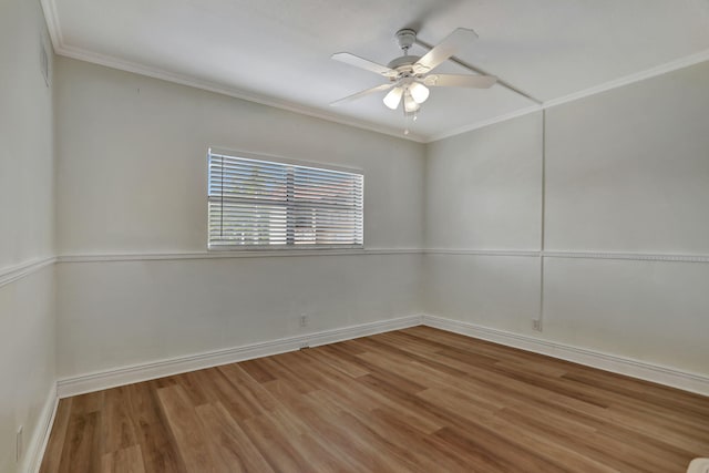 spare room with wood-type flooring, ornamental molding, and ceiling fan