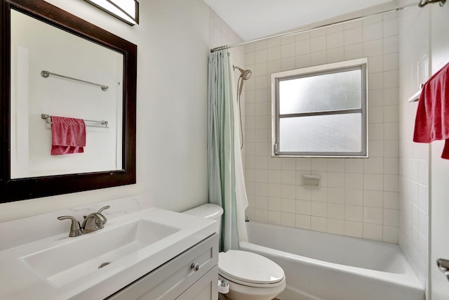 full bathroom featuring shower / bath combination with curtain, toilet, and vanity