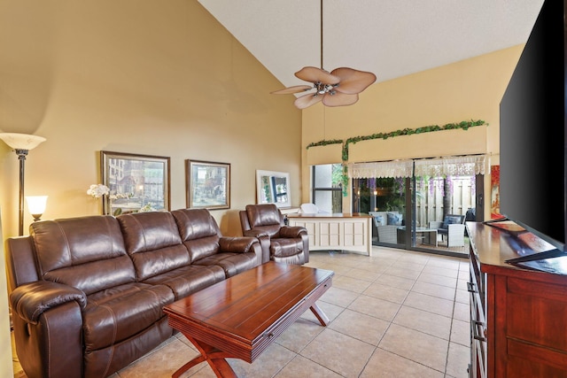 tiled living room with ceiling fan and high vaulted ceiling