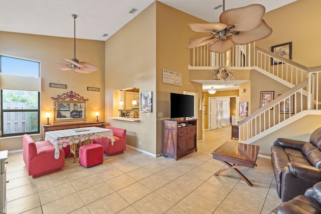 living room with light tile patterned floors, high vaulted ceiling, and ceiling fan