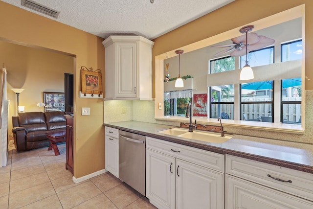 kitchen featuring ceiling fan, dishwasher, sink, hanging light fixtures, and light tile patterned floors