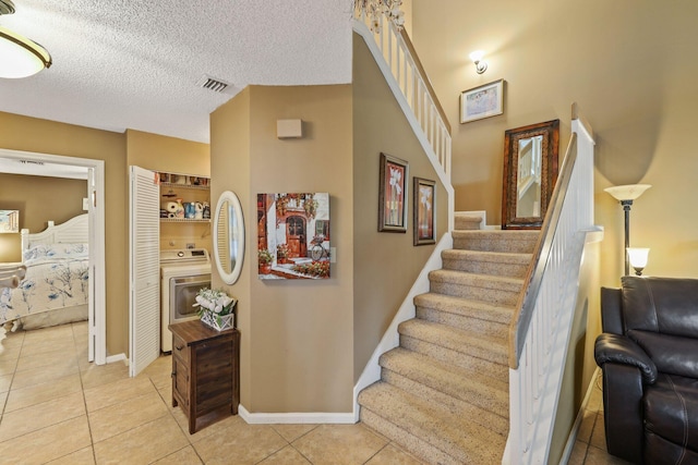 stairs featuring a textured ceiling and tile patterned floors