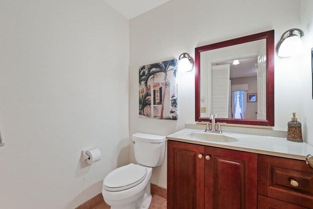 bathroom with tile patterned floors, vanity, and toilet