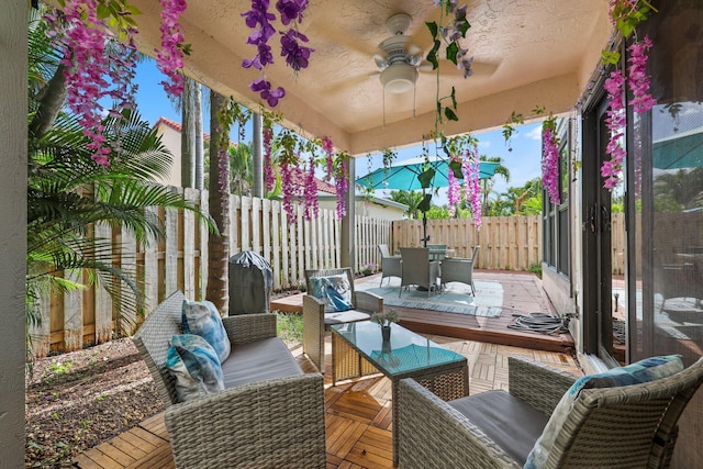 sunroom with ceiling fan and plenty of natural light