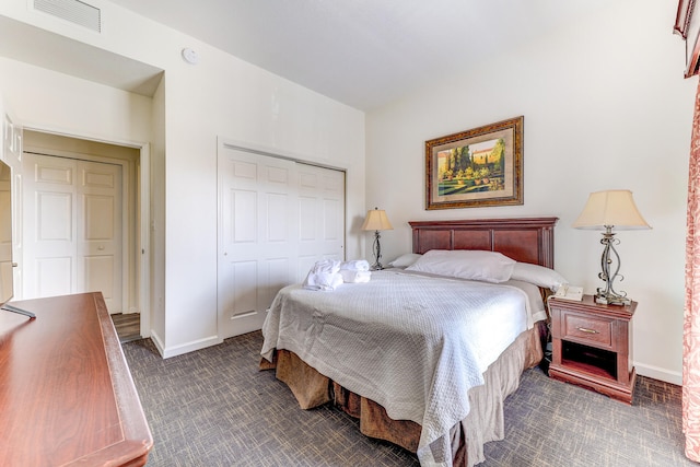 carpeted bedroom featuring a closet