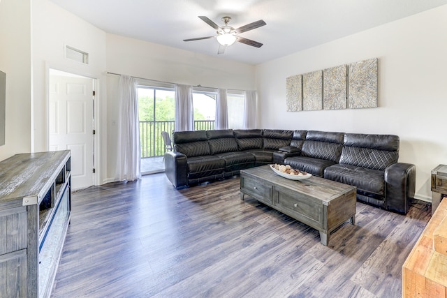 living room with dark hardwood / wood-style flooring and ceiling fan