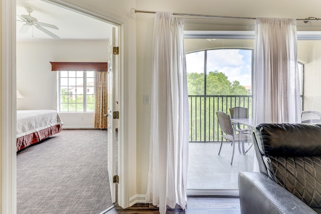 entryway with ceiling fan and carpet flooring