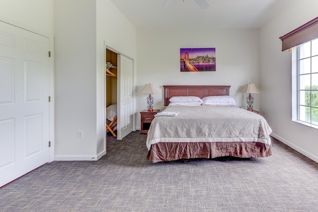 bedroom with dark carpet, ceiling fan, and a closet