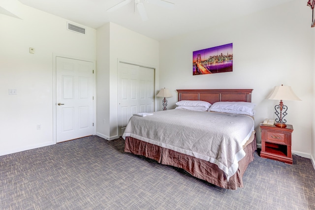 bedroom featuring dark colored carpet, a closet, and ceiling fan