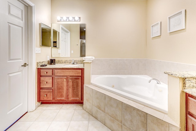 bathroom featuring vanity, tiled bath, and tile patterned floors