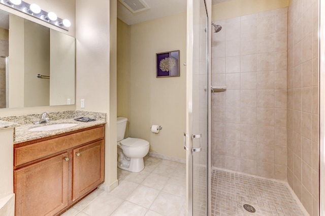 bathroom featuring tile patterned floors, toilet, vanity, and an enclosed shower