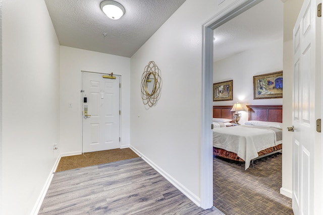 entryway featuring wood-type flooring and a textured ceiling