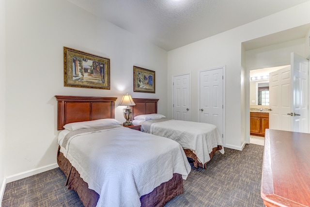 bedroom featuring multiple closets and ensuite bath