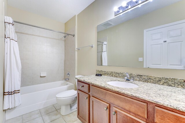 full bathroom with tile patterned flooring, toilet, vanity, and shower / tub combo with curtain