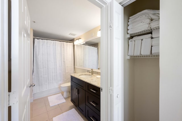 bathroom featuring tile patterned flooring, toilet, and vanity