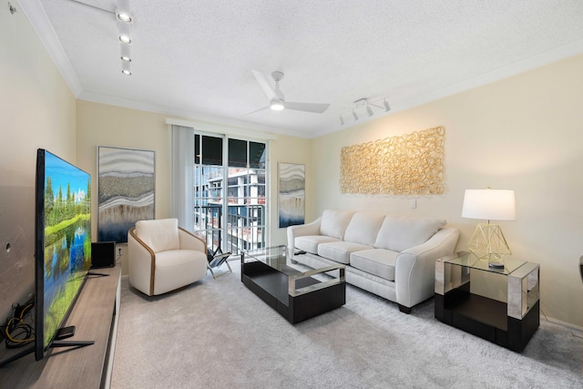 carpeted living room with a textured ceiling, ceiling fan, crown molding, and track lighting