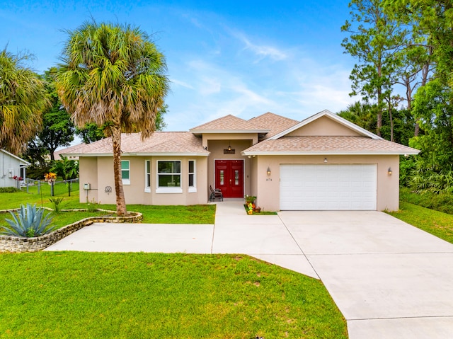 view of front of home featuring a front yard and a garage