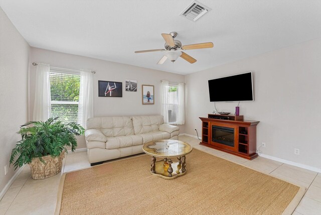 living room featuring light tile patterned flooring, a wealth of natural light, and ceiling fan