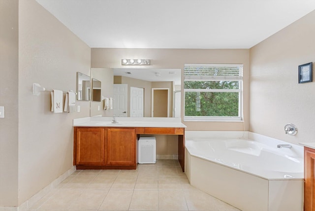 bathroom featuring vanity, tile patterned flooring, and a bath