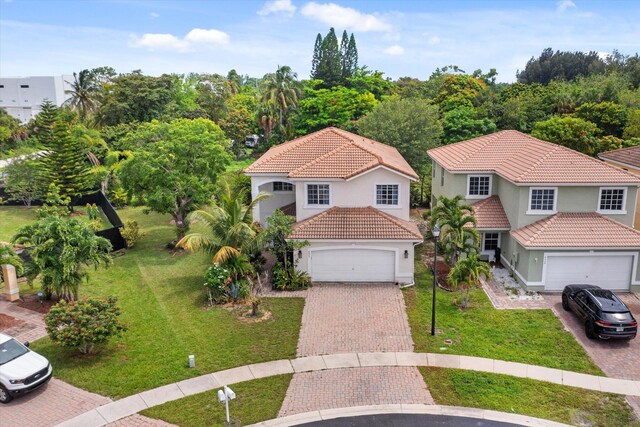 mediterranean / spanish house with a garage and a front yard