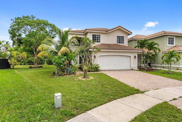 mediterranean / spanish home featuring a tile roof, a front lawn, decorative driveway, and stucco siding