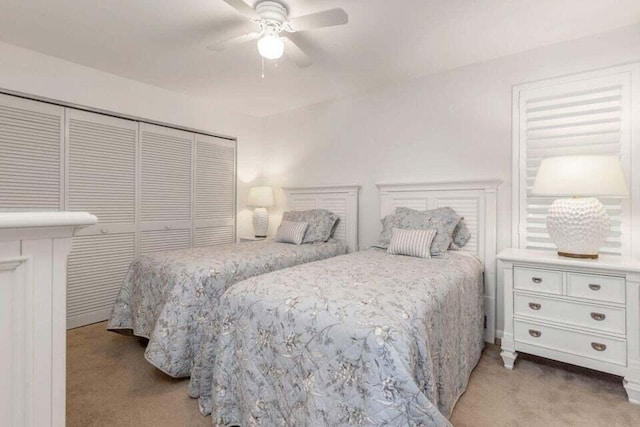 carpeted bedroom with a closet and ceiling fan